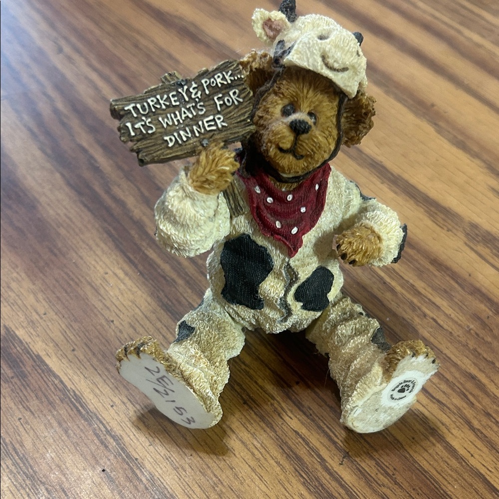 Bear Figurine in Cow Costume with Sign